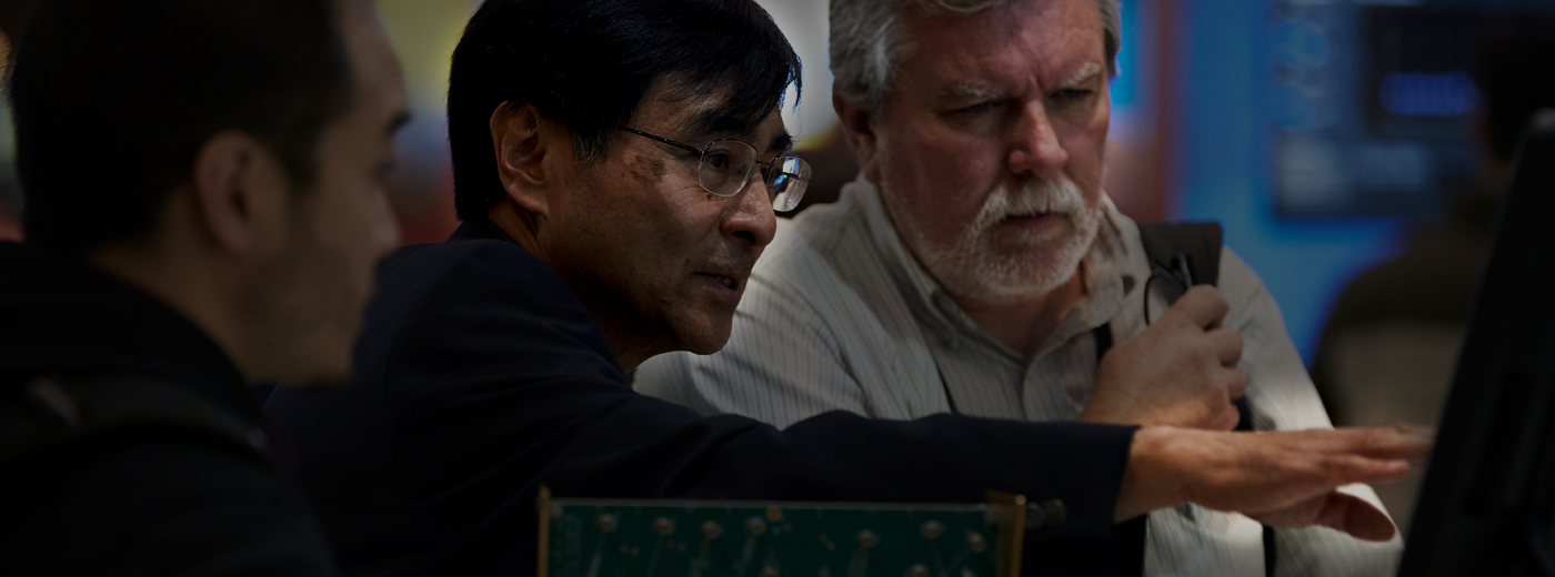 Attendees analyze image on computer screen