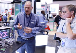 Exhibitor demonstrates product to attendee photo