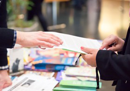 Person hands document to another person photo