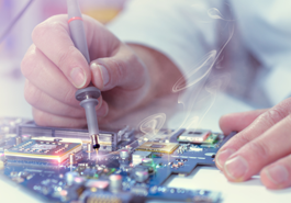 Man works on circuit board photo